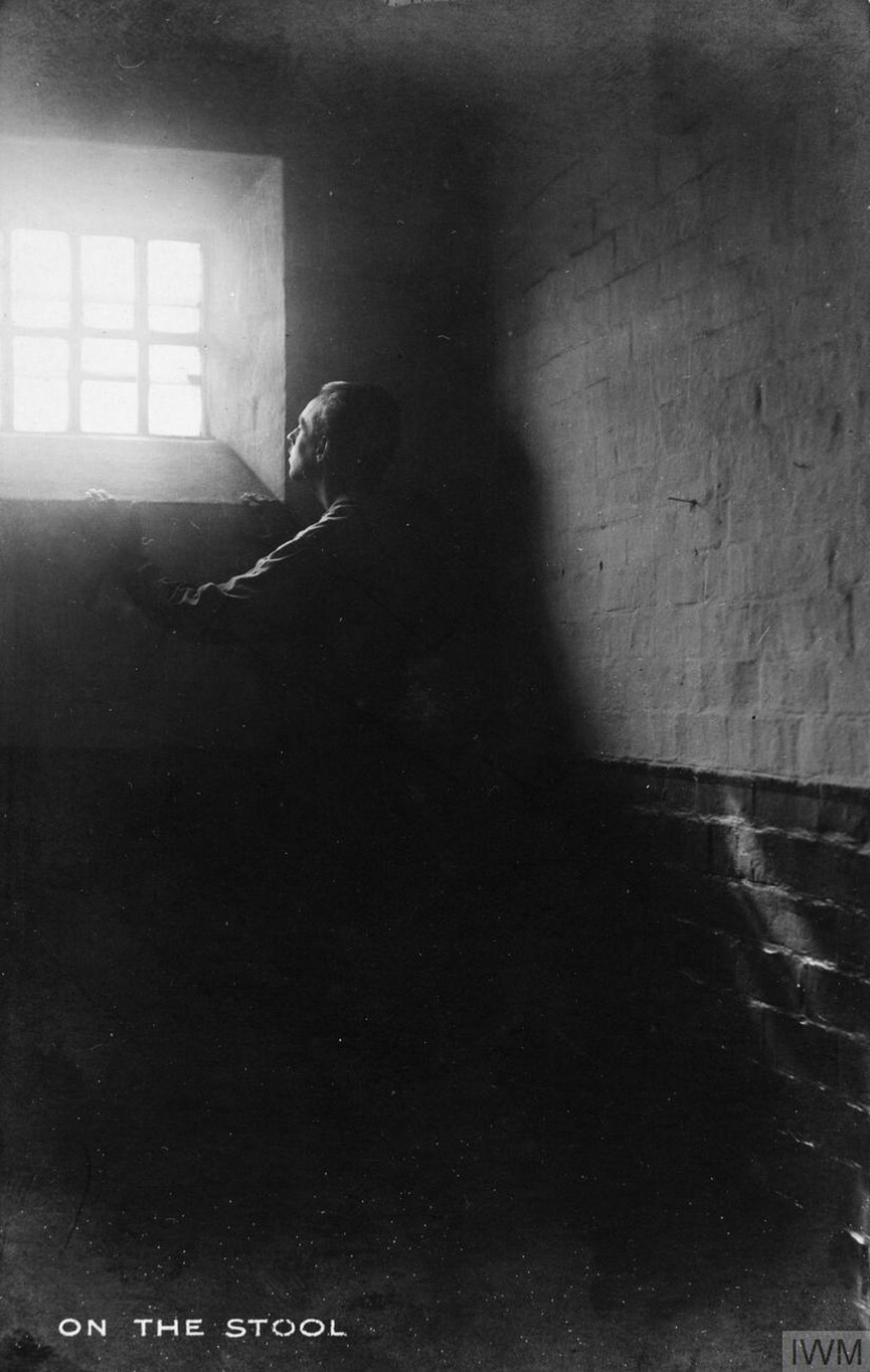 CO in Prison - Prisoner stands on a stool in a dark cell